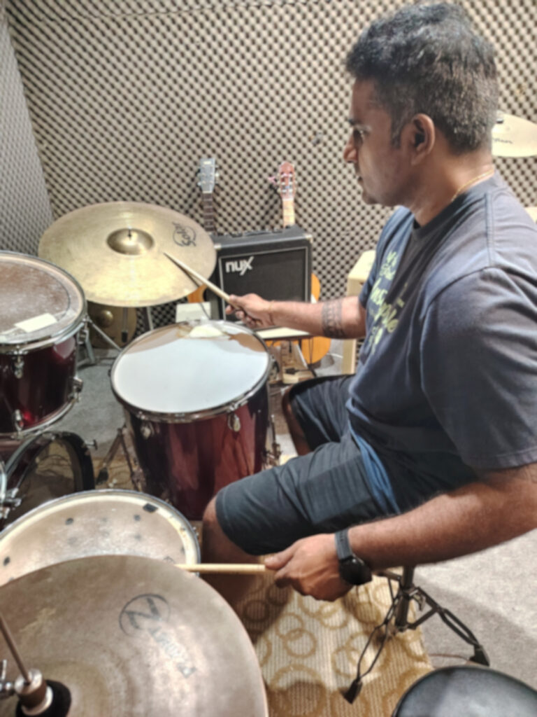 Adult student first time trying out drum kit in class