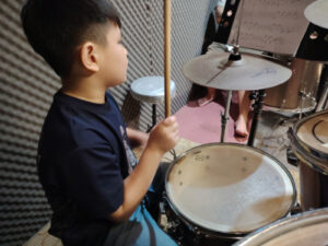 Child student reading sheet music during lesson