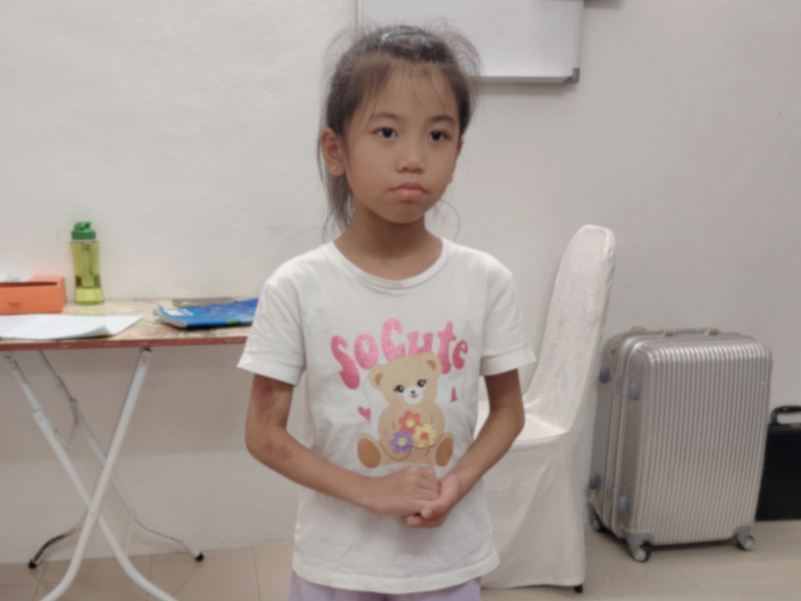 A child performing vocal exercises in a singing class with expressive hand movements