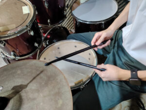 Close-up of hands playing drum kit