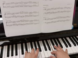 Close-up of a student hands playing piano scales