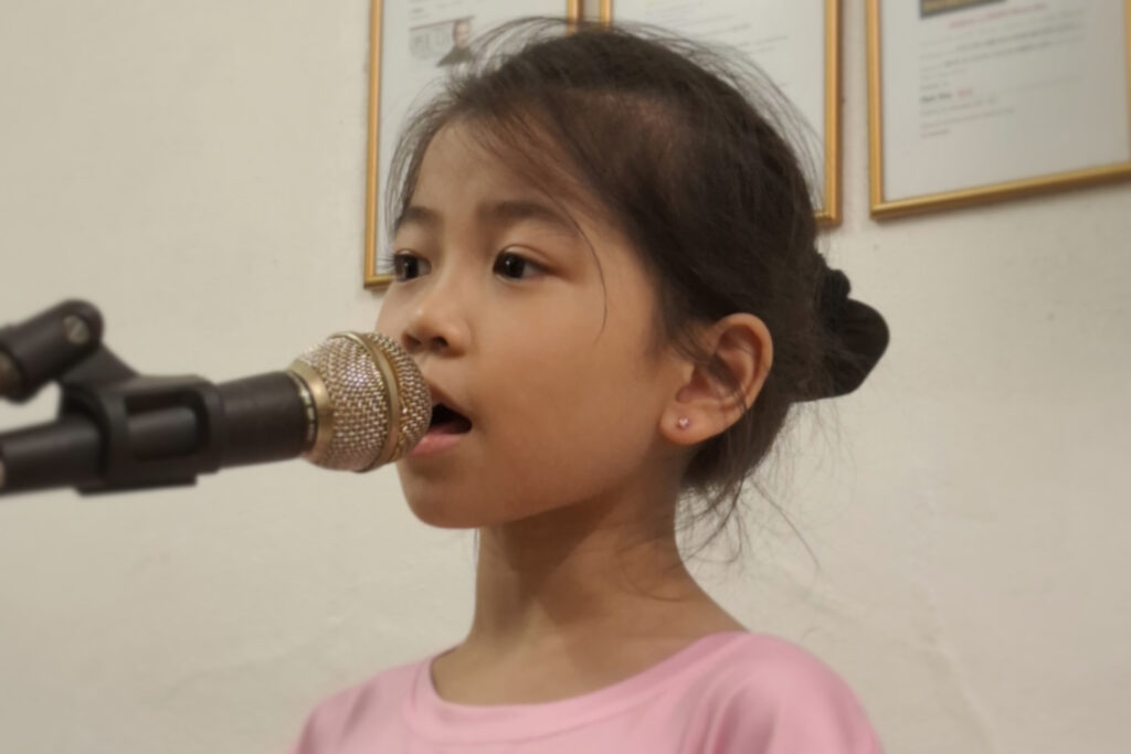Child student singing in class